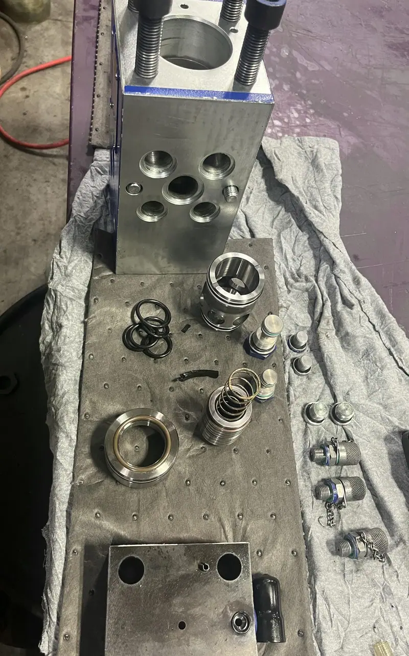 Actuator components laid out on a bench for rebuild